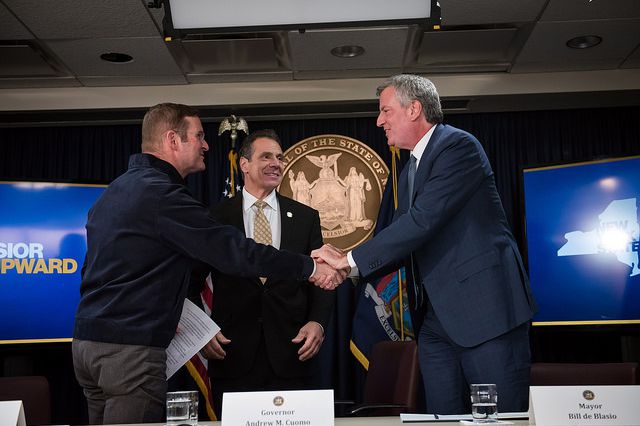 Mayor Bill de Blasio and Governor Andrew Cuomo celebrate the Amazon VP of Global Real Estate and Facilities John Schoettler